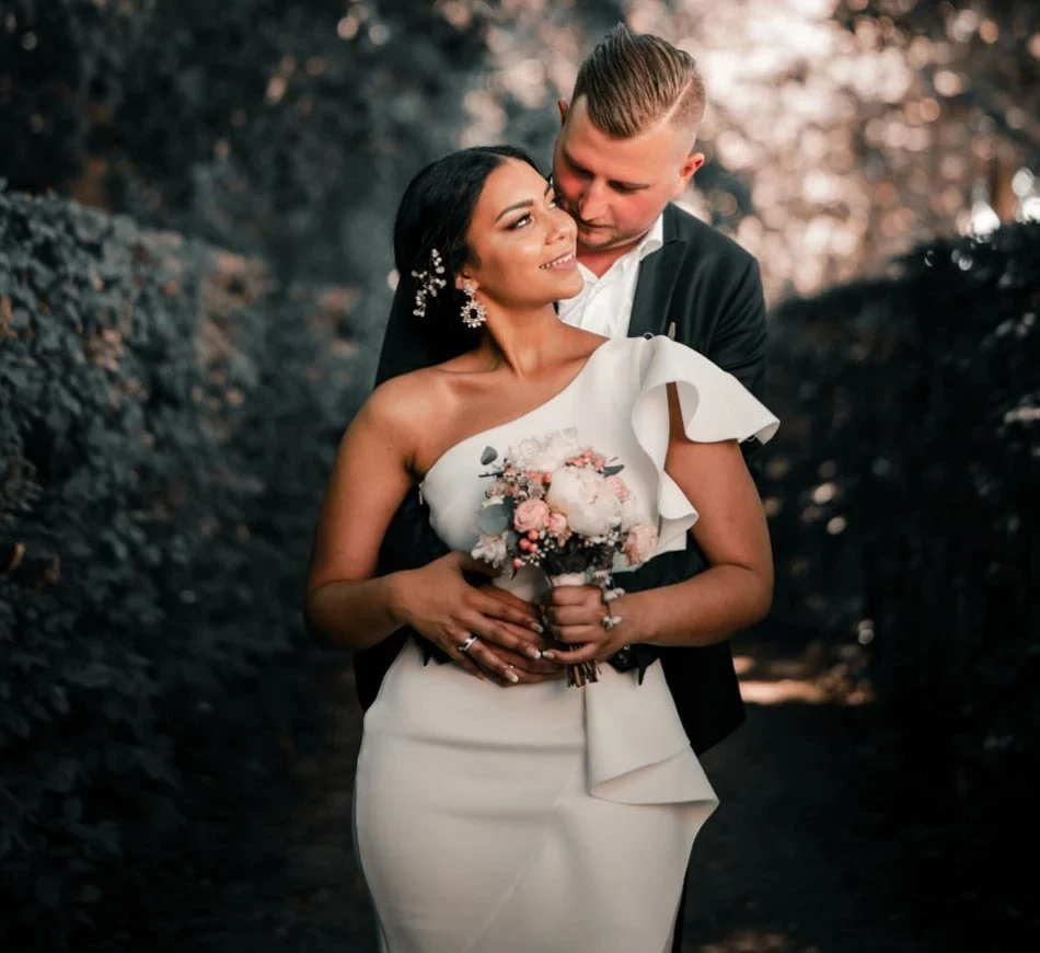 Image of a bride wearing a wedding dress and a groom in suit.
